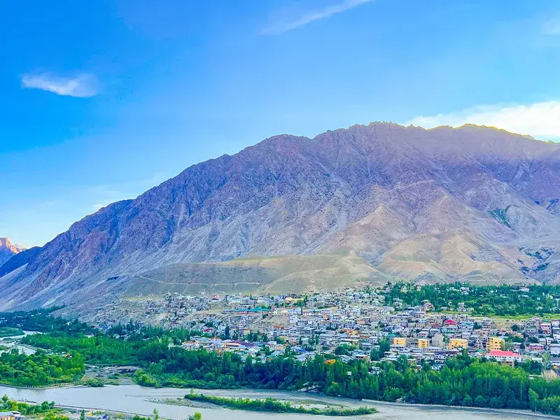 View of Kargil town surrounded by rugged Himalayan hills and flowing Suru River
